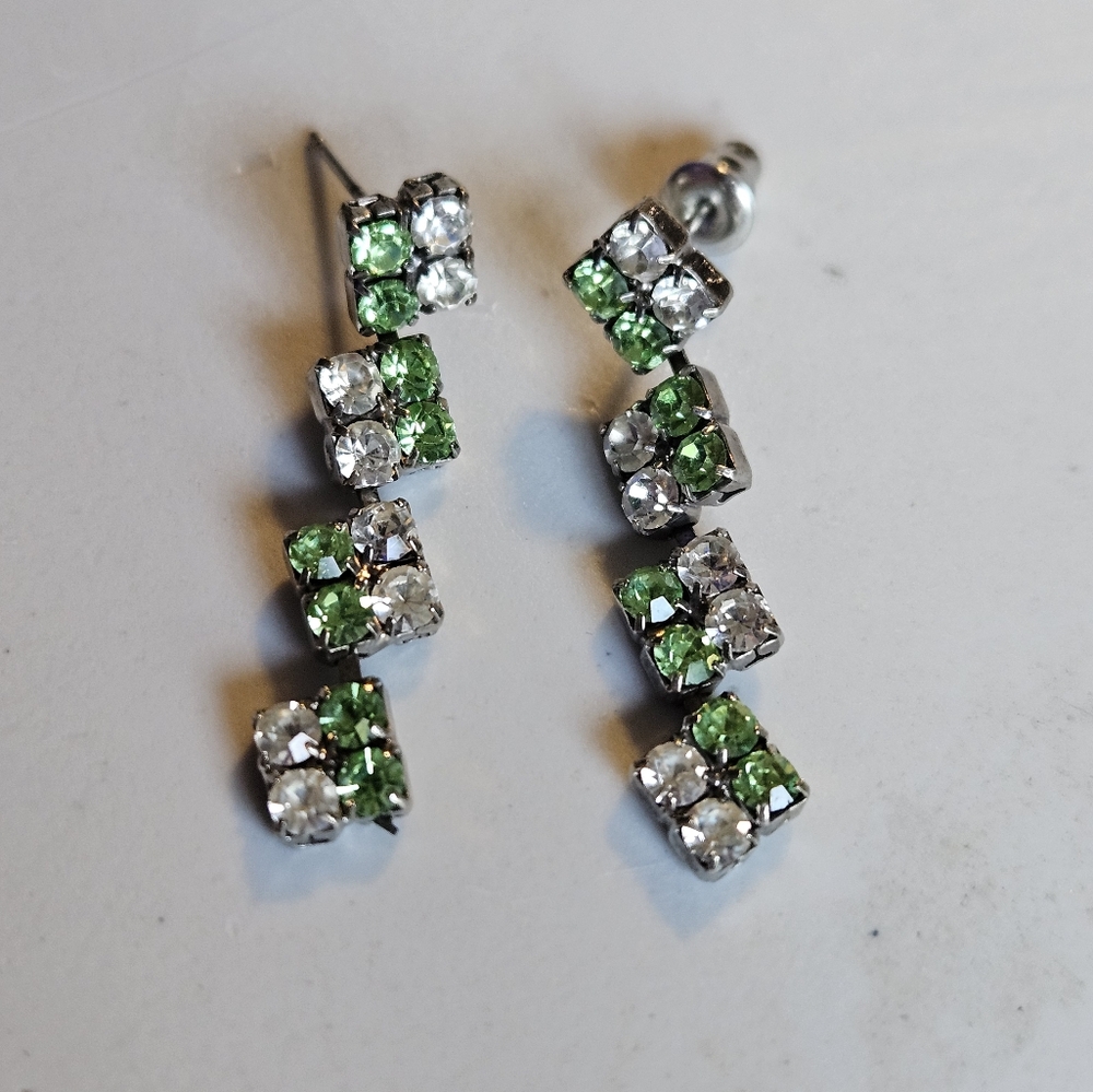 Silvertone dangle earrings with green and clear rhinestones.